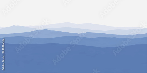 Misty mountain landscape with clouds and a calm lake at sunrise in the morning