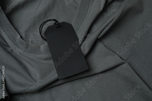 Rectangular clothing tag on a gray t-shirt
