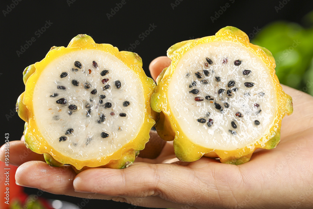 Fototapeta premium Fresh Yellow Dragon Fruit Kiwano Horned Melon Halves with Seeds Hainan Tropical Exotic Delicious Fruit