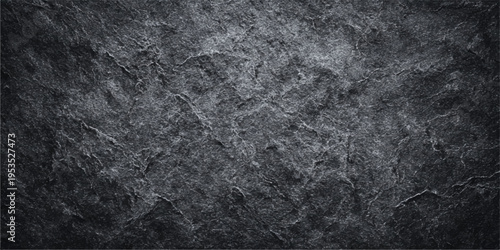 Seamless dark gray asphalt texture background with a grungy black stone surface pattern and aged rough material for a vintage wall design