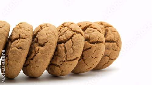 A row of freshly baked gingerbread cookies on a white surface