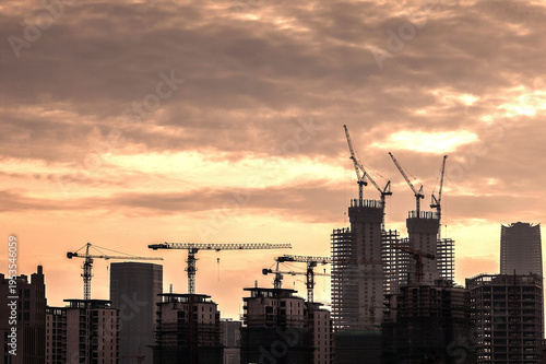 Photos Urban Development Process at Sunset with Construction Cranes
