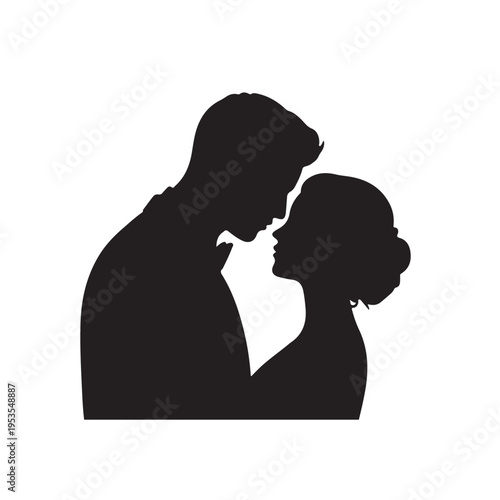 Black silhouette of groom kissing bride on wedding day