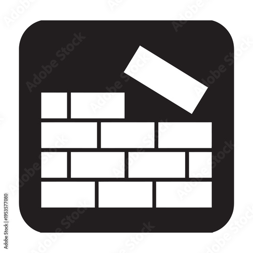 Construction worker placing rectangular brick on wall