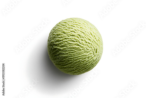 A green melon sitting on a white surface with a subtle shadow underneath