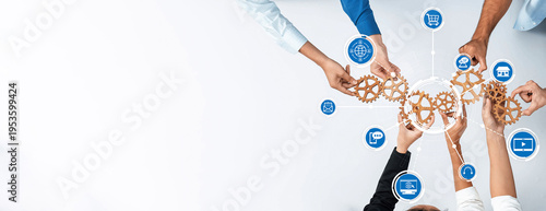 Картината върху платно A top-down view of diverse hands working together with gears and technology icons, symbolizing collaboration and innovation in a modern business setting
