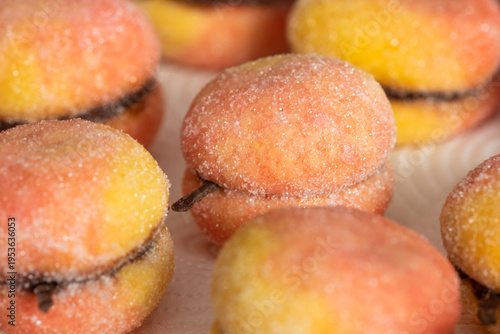 Peach-shaped pastries on a white background