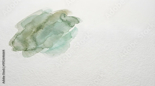 Abstract green watercolor wash on textured paper background with copy space.