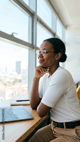 Wallpaper Mural Ambitious woman in glasses looking out office window, contemplating future success and career goals. Torontodigital.ca