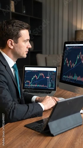 Wallpaper Mural Businessman in formal attire analyzes stock market charts on multiple computer screens in office Torontodigital.ca