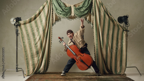 Bild auf Leinwand Teen boy playing cello energetically on stage expressive classical music performance