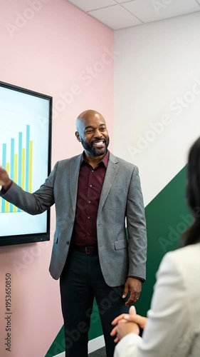 Wallpaper Mural Smiling businessman presenting a financial graph on a large screen in a modern meeting room Torontodigital.ca