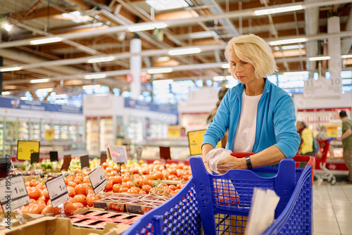 Картината върху платно Woman buying fresh produce at a supermarket