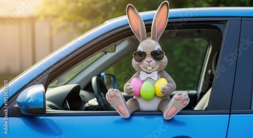 A cute easter bunny wearing cool sunglasses and a bowtie sitting on the window of a blue vehicle