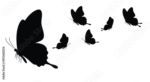 A group of black silhouette butterflies in flight against a white background