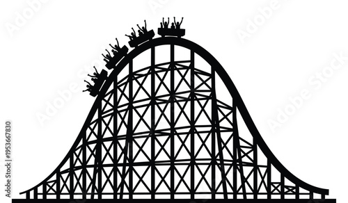 Silhouette of a classic wooden roller coaster with riders in silhouette