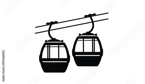 Silhouette of two cable car cabins suspended from overhead cables
