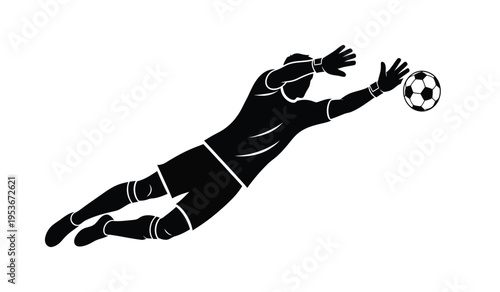 Soccer goalkeeper in diving silhouette saving ball from scoring