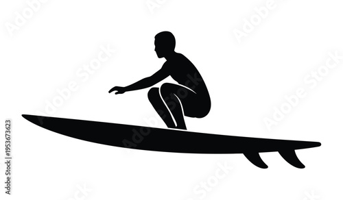 Photography Silhouette of a person surfing on a surfboard in a crouched position