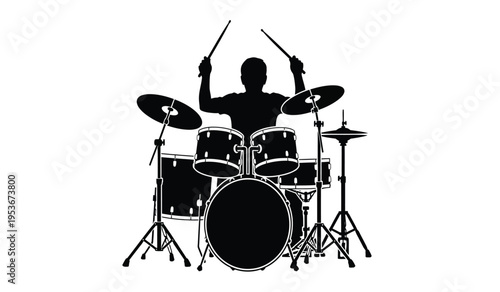 Silhouette of a drummer playing a drum set with sticks