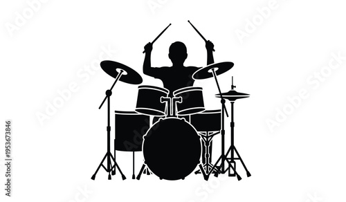 Silhouette of a drummer playing a drum set with sticks