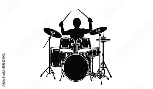 Silhouette of a drummer playing a drum set with sticks