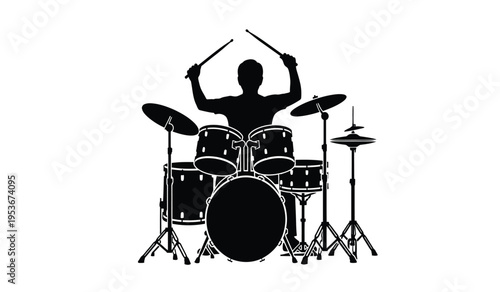 Silhouette of a drummer playing a drum set with sticks