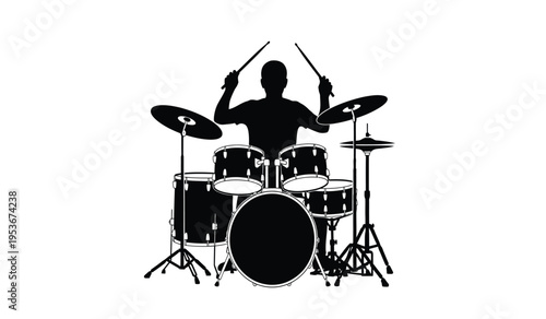 Silhouette of a drummer playing a drum set with sticks