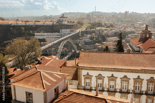 Bild auf Leinwand Elevated view over Porto rooftops towards the iconic iron bridge Dom Luís I and Serra do Pilar monastery, capturing the historic urban landscape