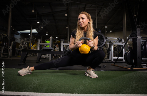 Fitness and health concept. A fit young woman works out in a modern gym. Athletic man doing exercise.