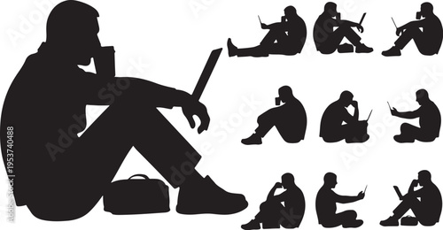 Silhouette of man sitting with laptop and phone