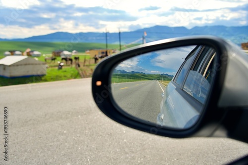 Billede på lærred Car Rearview Mirror on Road Trip