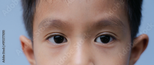 Close up little Asian  boy's eye with looking straight to the target. Healthy life concept.