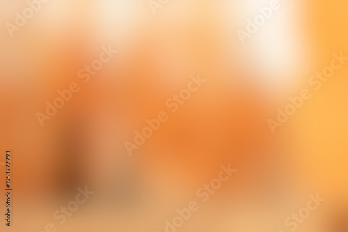 Blurred warm autumn background with fallen leaves, out of focus, gradient backdrop