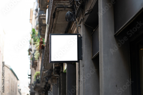 Blank square signage mockup displaying brand identity on an old urban building, ready for custom logo design, marketing, and street advertising in a city