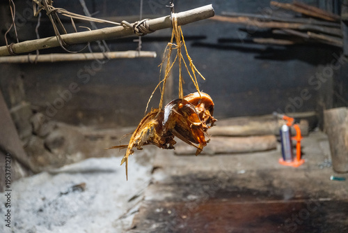 Bild auf Leinwand Lanyu, Taiwan: Traditional smoked flying fish hanging above the hearth inside a Tao underground house, Orchid Island