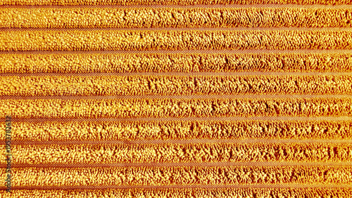 plush striped golden orange terry towel macro texture with soft loops and woven accents in warm vibrant hues