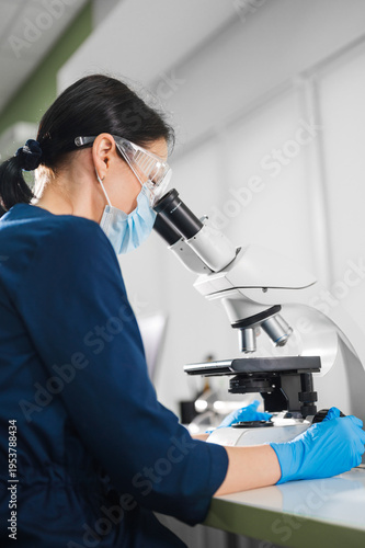 Wallpaper Mural Expert In Viruses Examines Cultures Under Microscope While Following Strict Safety And Containment Procedures Torontodigital.ca