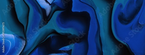 Abstract acrylic pour fluid art background in black and dark blue tones with marble texture and wavy pattern