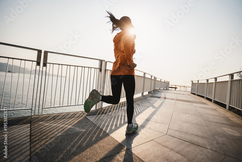 Fitness woman runner running at seaside