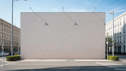 Large blank white billboard on a street corner in a city, with buildings and cars, for advertising