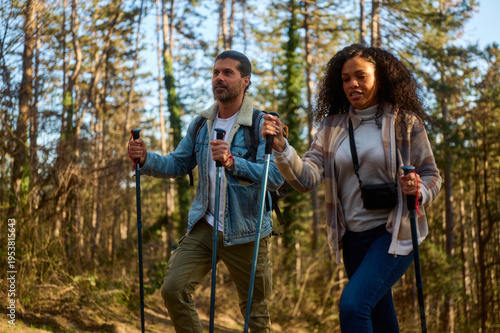 Fotografie Diverse couple enjoying an active outdoor lifestyle, walking through a natural f