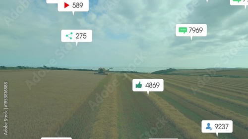 Yellow combine harvester harvesting golden wheat field, floating social icons highlighting metrics