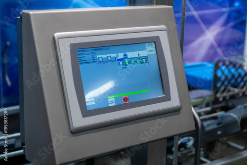 A close-up shot of an industrial control panel featuring an touchscreen display, showcasing the machine interface for a manufacturing process during an exhibition in Helsinki, Finland