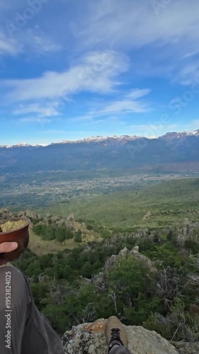 POV of a person holding a traditional yerba mate gourd high in the mountains.