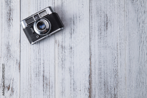 Fotografie Vintage Rangefinder Camera on Whitewashed Wood Surface