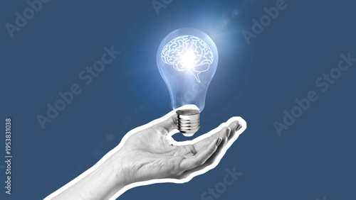 Light bulb held in hand with a brain inside shining light in a creative concept