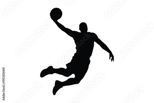 Silhouette of a basketball player in mid air preparing to dunk