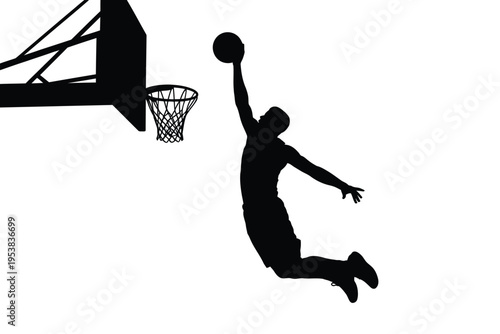 Silhouetted basketball player in mid air preparing to dunk the ball