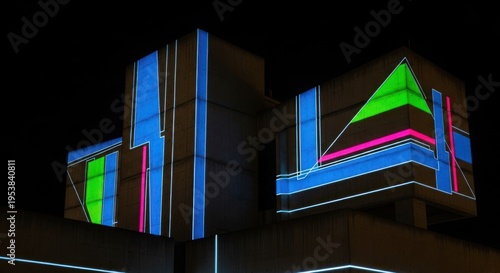 Vibrant geometric light projection on brutalist architecture at night